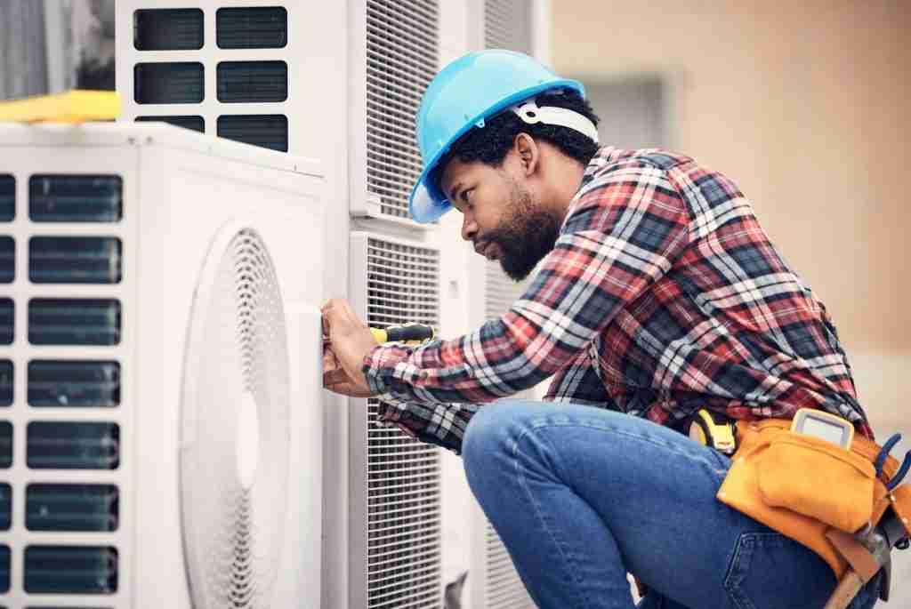 Professinoal Heating and Air, HVAC in Puyllap | Black man, electrician and maintenance on air conditioner with engineering and handyman working